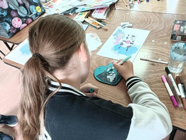 girl drawing on slate with acrylic pens