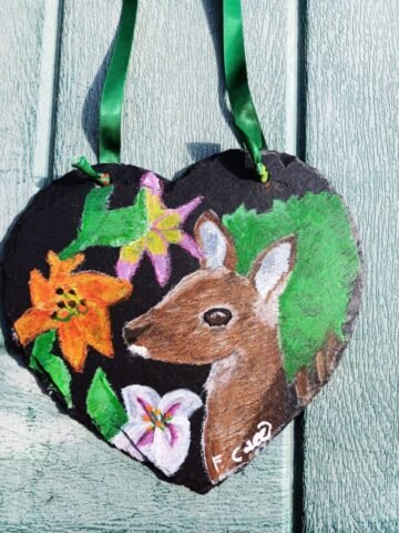 painting on a slate heart of a deer and flowers