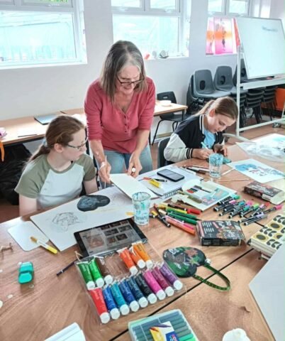 Young people creating original art with Tracey Emmett using sketching and painting